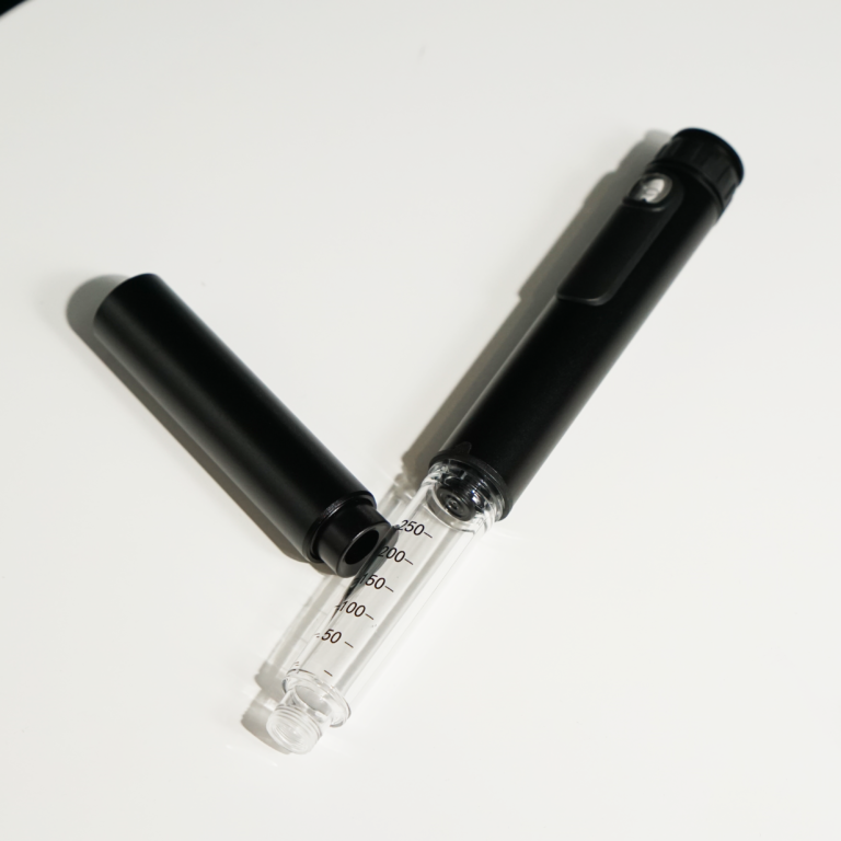 Black PepPen with its cap off showing a 3 mL glass cartridge